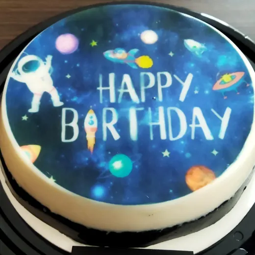 Gelatina redonda con imagen comestible espacial y la frase Happy Birthday